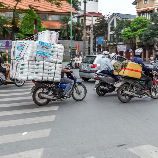 Motorbike taxi and courier riders in the heat; Hanoi, Vietnam.