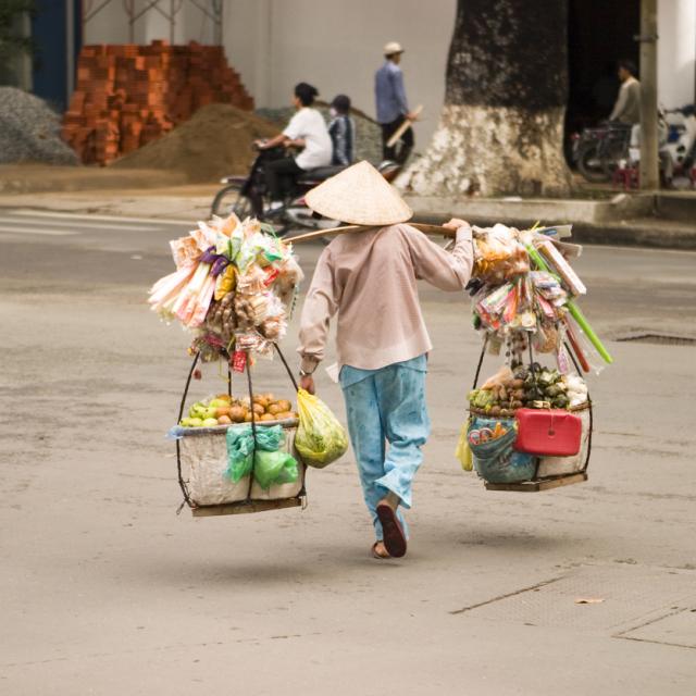 Street vendor crossing street in Vietnam