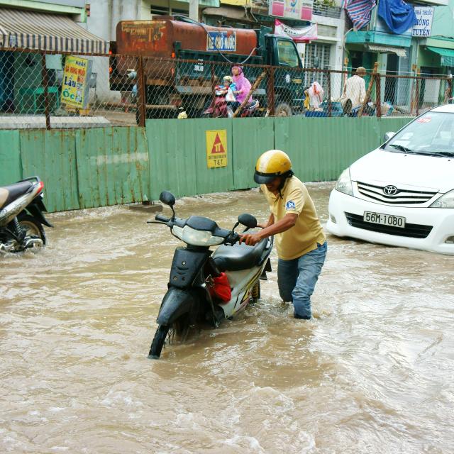 Ho Chi Minh city, VietNam - October 2, 2014: Motorists struggle in flooded streets