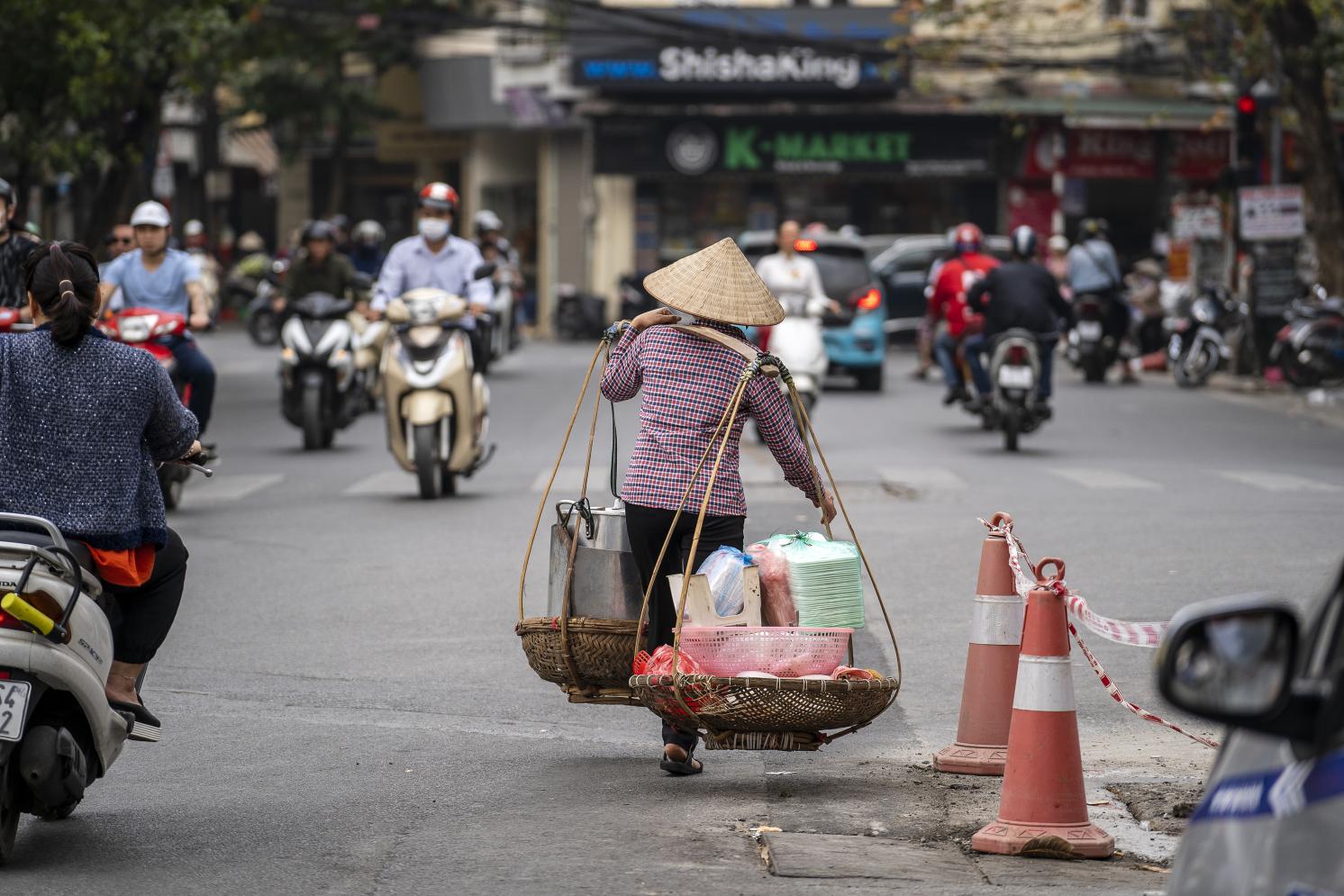 Food vendor working outdoors in Vietnam