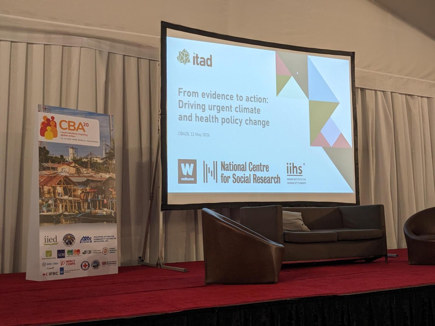 Panel discussion title displayed on a screen at an event 